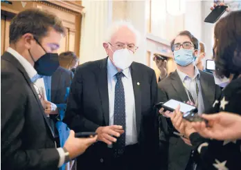  ?? AL DRAGO/THE NEW YORK TIMES ?? U.S. Sen. Bernie Sanders, I-Vt., seen talking to reporters Oct. 6, is very upset that the Democrats’“Build Back Better” package is stalled.
