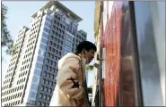  ?? NG HAN GUAN — THE ASSOCIATED PRESS ?? A man gets swabbed for COVID test near a building of the Peking University in Beijing on Wednesday.