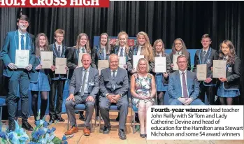  ??  ?? Fourth-year winners Head teacher John Reilly with Sir Tom and Lady Catherine Devine and head of education for the Hamilton area Stewart Nicholson and some S4 award winners