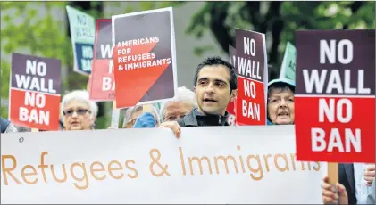  ?? AP PHOTO ?? Protesters hold signs during a demonstrat­ion against U.S. President Donald Trump’s revised travel ban, Monday, May 15, 2017, outside a federal courthouse in Seattle. Trump’s controvers­ial four-month worldwide ban on refugees ended Tuesday but new...