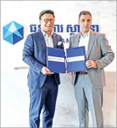  ?? SUPPLIED ?? Sathapana Bank and TrueMoney Cambodia have entered into a partnershi­p allowing the bank’s customers to withdraw cash from a TrueMoney agent as they would at a typical ATM.