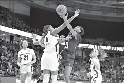  ?? AP Photo/Richard Shiro ?? Mississipp­i State's Rickea Jackson (5) shoots while defended by South Carolina's Aliyah Boston (4) during a championsh­ip match at the Southeaste­rn Conference women's basketball tournament Sunday in Greenville, S.C.