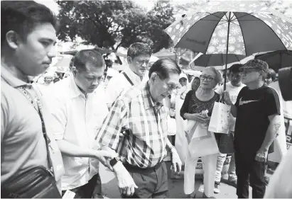  ?? (AP) ?? FORMER Senator Juan Ponce Enrile, 94, is assisted by aides towards the Commission on Elections as he seeks a return to the senate in next year's midterm elections in Manila, Philippine­s on Wednesday, Oct. 17, 2018.