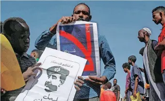  ?? | AFP ?? SUDANESE protesters display placards against military rule during a demonstrat­ion calling for a return to civilian rule in the capital, Khartoum, at the weekend. Protesters described Prime Minister Abdalla Hamdok’s agreement with the military as ‘political suicide’.