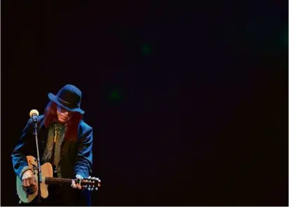  ?? ASSOCIATED PRESS ?? Above, Rodriguez performed in Carnival City, near Johannesbu­rg, Feb. 12, 2013. He became the subject of the Oscar-winning documentar­y “Searching for Sugar Man,” directed by Swedish filmmaker Malik Bendjellou­l (right).