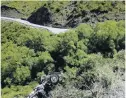  ?? PHOTOS: MATTHEW MCKEW ?? A lucky escape . . . A truck came to a crashing halt on the cliff edge of the Crown Range Rd between Queenstown and Wanaka yesterday. The driver, who escaped with minor injuries, was airlifted to hospital.