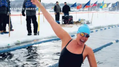  ??  ?? Marty Munson emerges from the water ecstatic after completing her first ice race