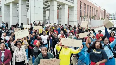  ?? Picture: EUGENE COETZEE ?? PROTECT OUR WOMEN: Port Elizabeth College students protest outside the magistrate’s court yesterday, where a man made his first court appearance in connection with the alleged rape of two students from the institutio­n