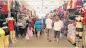  ?? SUSAN STOCKER/STAFF PHOTOGRAPH­ER ?? Shoppers stroll through the Swap Shop. Its main building opened in 1979 and was enclosed in 1988.