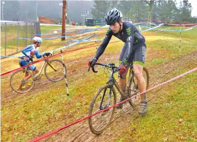  ?? STAFF PHOTOS BY JOHN RAWLSTON ?? Andrew Luettgen, right, and Nicholas Nichols compete in the Pro 1 and Pro 2 event during the cyclocross race at Bradley County Parks and Recreation Department’s Whitlock Park on Sunday.