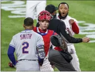  ?? LAURENCE KESTERSON — THE ASSOCIATED PRESS ?? Phillies relief pitcher Jose Alvarado, right, has an altercatio­n with the Mets’ Dominic Smith (2) as catcher Andrew Knapp tries to intervene after Smith struck out swinging in the eighth inning.