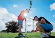  ?? [OKLAHOMAN ARCHIVES PHOTO] ?? Westwood Golf Course profession­al Rick Parish helps a young golfer line up a shot at a past junior golf clinic. A new clinic for young golfers starts on June 20.