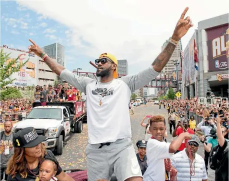  ??  ?? LeBron James salutes the fans during the Cavaliers’ NBA championsh­ip victory parade in June.