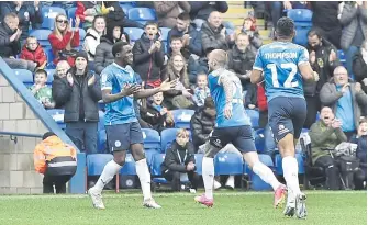  ?? ?? Kwame Poku (left) celebrates his part in the first goal v Exeter. Photo: David Lowndes.