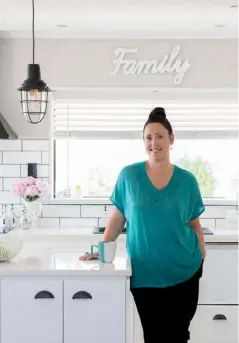  ??  ?? DESIGNER KITCHEN
Lisa’s modern country kitchen features a palette of calming white and crisp black detailing to replace the dark, dated look of the previous kitchen.