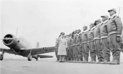  ?? Photograph: Anonymous/AP ?? Major James Ellison, left, returns the salute of Mac Ross of Dayton, Ohio, with cadets at the Tuskegee Institute in January 1942.