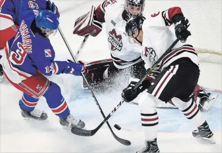  ?? DAVID BEBEE WATERLOO REGION RECORD ?? The Kitchener Rangers’ Riley Damiani, left, was turned away by Guelph goalie Nico Daws on this chance, but he got the last word in overtime.