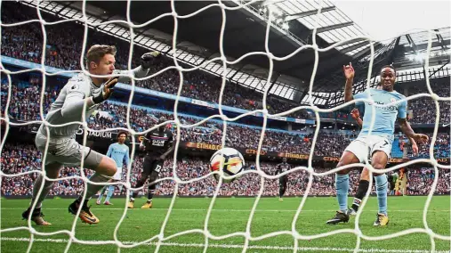  ?? — Reuters ?? Ruthless: Manchester City’s Raheem Sterling scoring one of his two goals in Manchester City’s 5- 0 demolition of Crystal Palace on Saturday.