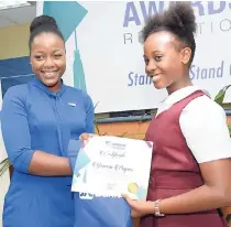  ?? BROWN/PHOTOGRAPH­ER RUDOLPH ?? Shanna Kaye Wright (left), youth marketing officer of JN Bank, presents a grant to JN School Savers scholarshi­p awardee Yanecia Poyser of Middlesex at the annual JN Foundation 2018 Scholarshi­p Awards Ceremony on Sunday.