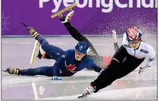  ??  ?? PAINFUL END: British speed-skater Elise Christie (left) tumbles out of the 1500m semi-final, taking China’s Li Jinyu with her