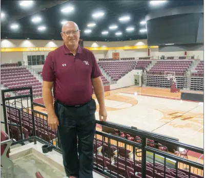  ?? MARK BUFFALO/TRILAKES EDITION ?? Rick Waters, the new athletic director for the Lake Hamilton School District in Pearcy, stands on the concourse of Wolf Arena, which opened during the 2016-17 school year. Waters, who was previously superinten­dent of the Genoa Central School District in Texarkana, was hired by the Lake Hamilton district in June and started as AD on July 1. This year is his 32nd year in education.