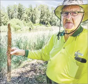  ??  ?? Peter Sheridan from the Wellington Canoe Club, holding part of a steel star picket that members found in the river and cut the top off. PHOTO: DUBBO PHOTO NEWS