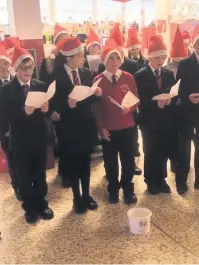  ??  ?? Carol singing children from Hurdsfield Primary