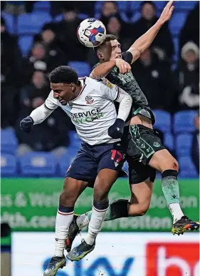  ?? ?? Bobby Thomas has an aerial battle with Bolton’s Dapo Afolayan