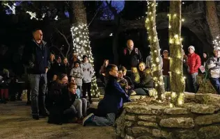  ?? Sam Owens / Staff photograph­er ?? People listen to musicians from Living Word Lutheran Church sing Christmas carols Dec. 11 during a caroling event at Natural Bridge Caverns.