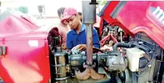  ??  ?? Technical crew attend to Mahindra tractors brought to DIMO - Mahindra Tractor Service Camp