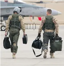  ?? O P I MPAC T / D N D ?? Two pilots at the Canadian airbase in Kuwait return from a mission against ISIL in January.