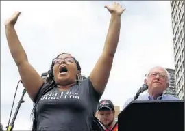  ?? Alan Berner
Seattle Times ?? MARISSA JOHNSON protests next to Bernie Sanders in Seattle in August. Candidates have been shouted down by groups that might usually be seen as allies.