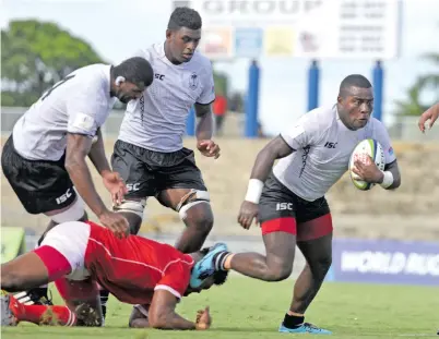  ?? Photo: Ronald Kumar ?? Fijian Warriors winger Veramu Dikidikila­ti takes on the Tongan defence during World Rugby Pacific Challenge at the ANZ Stadium, Suva, on March 17, 2018.