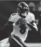  ?? WADE PAYNE/AP ?? Ravens quarterbac­k Lamar Jackson scrambles against the Titans on Sunday.