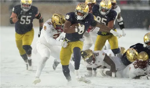  ?? AP ?? Notre Dame running back Logan Diggs, who ran for 122 yards and a touchdown, gets tackled by Boston College linebacker Bryce Steele in the second half.