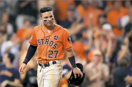  ?? Ronald Martinez/Getty Images ?? Houston’s Jose Altuve celebrates after sliding into home to score on a single by Carlos Correa in the fourth inning Friday.