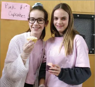  ?? ANDREA PEACOCK/ The Daily Courier ?? Dr. Knox Middle School students Mikayla Lang and Braelyn Whitney hold pink cupcakes on Pink Shirt Day.