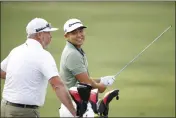  ?? CLIFF HAWKINS — GETTY IMAGES ?? Chico’s Kurt Kitayama talks with caddie Tim Tucker on the range during a practice round prior to The Players Championsh­ip on The Players Stadium Course at TPC Sawgrass on Tuesday in Ponte Vedra Beach, Florida.