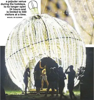  ?? MIGUEL DE GUZMAN ?? A couple takes selfies inside a giant Christmas ball, part of the holiday decoration­s in Rizal Park in Manila the other night. The park, a popular venue during the holidays, is no longer open 24 hours and is limited to 500 visitors at a time.