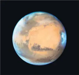  ?? NASA ?? LIKE EARTH, Mars experience­s ice ages, but the mechanics are different. As a result, a Martian ice age means less ice at the poles and more near the middle.