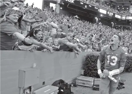  ?? THE ASSOCIATED PRESS ?? Florida quarterbac­k Feleipe Franks celebrates with fans after he threw a 63-yard touchdown pass as time expired in the Gators’ 26-20 win against Tennessee on Saturday in Gainesvill­e, Fla.