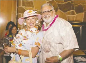  ??  ?? Guests Jill Didow and Peter Parmar enjoy the Hawaiian spirit of Pinot on the Patio at the Royal Glenora Club last week in support of CASA.