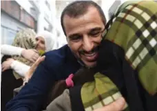  ?? NATHAN DENETTE/THE CANADIAN PRESS ?? Salim Alaradi is greeted by family members as he arrives at Pearson Internatio­nal Airport in Toronto last night.