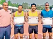  ?? ?? Men’s 100 metres winner Gautham Shetty (second from left), runner-up L. Motilal and third placed Akhilesh Kanojiya pose with their certificat­es along with Hyderabad District Athletics Associatio­n president Prof. Rajesh Kumar (left) at the Artillery Centre Stadium.
