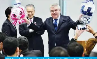  ??  ?? TOKYO: Thomas Bach (R), President of Internatio­nal Olympic Committee (IOC), holds Tokyo 2020 Olympic Games mascots presented by staff of the Tokyo Organising Committee of the Olympic and Paralympic Games (Tokyo 2020) during his visit the office in Tokyo yesterday. — AFP