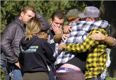  ?? DAVID CRANE — SOUTHERN CALIFORNIA NEWS GROUP ?? People await word about the fate of loved ones at the Thousand Oaks Teen Center after a shooting at the nearby Borderline Bar &amp; Grill on Wednesday night. Thirteen people, including a sheriff’s deputy and the shooter, died in the massacre.