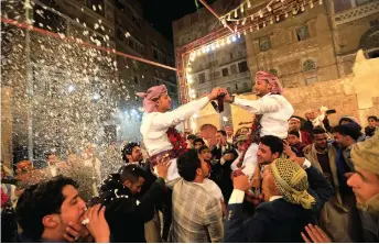  ??  ?? Yemenis dance at a wedding ceremony in the old city of Sanaa.