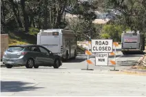  ??  ?? Above: A “road closed” sign indicates a full parking lot at Baker Beach, and a driver makes a detour around the sign.