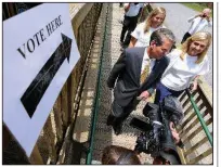  ?? AP/Atlanta Journal-Constituti­on/CURTIS COMPTON ?? Georgia Secretary of State Brian Kemp, accompanie­d by his wife and daughter, leaves the Wintervill­e Train Depot after voting Tuesday in Georgia’s runoff election.