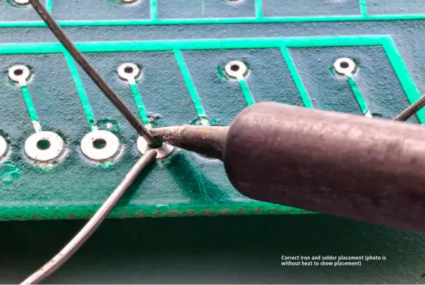  ??  ?? Correct iron and solder placement (photo is without heat to show placement)